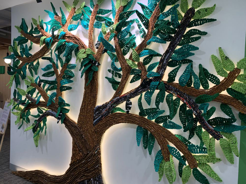 A tree installation art made from old shirts and other discarded materials 